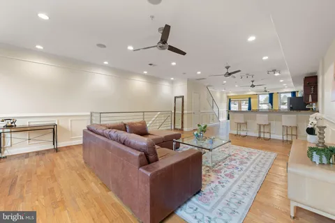 a living room with furniture and kitchen view