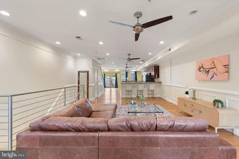 a living room with furniture and a ceiling fan