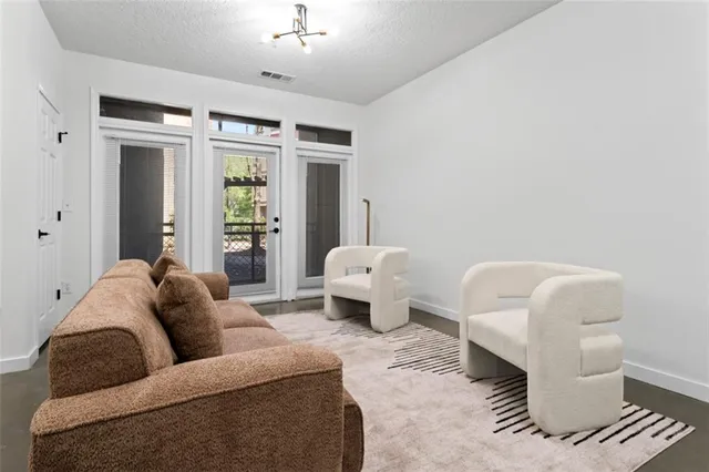 a living room with furniture and a large window