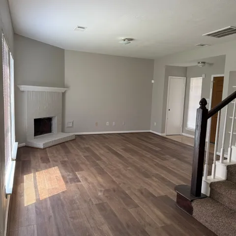 wooden floor in an empty room with a fireplace