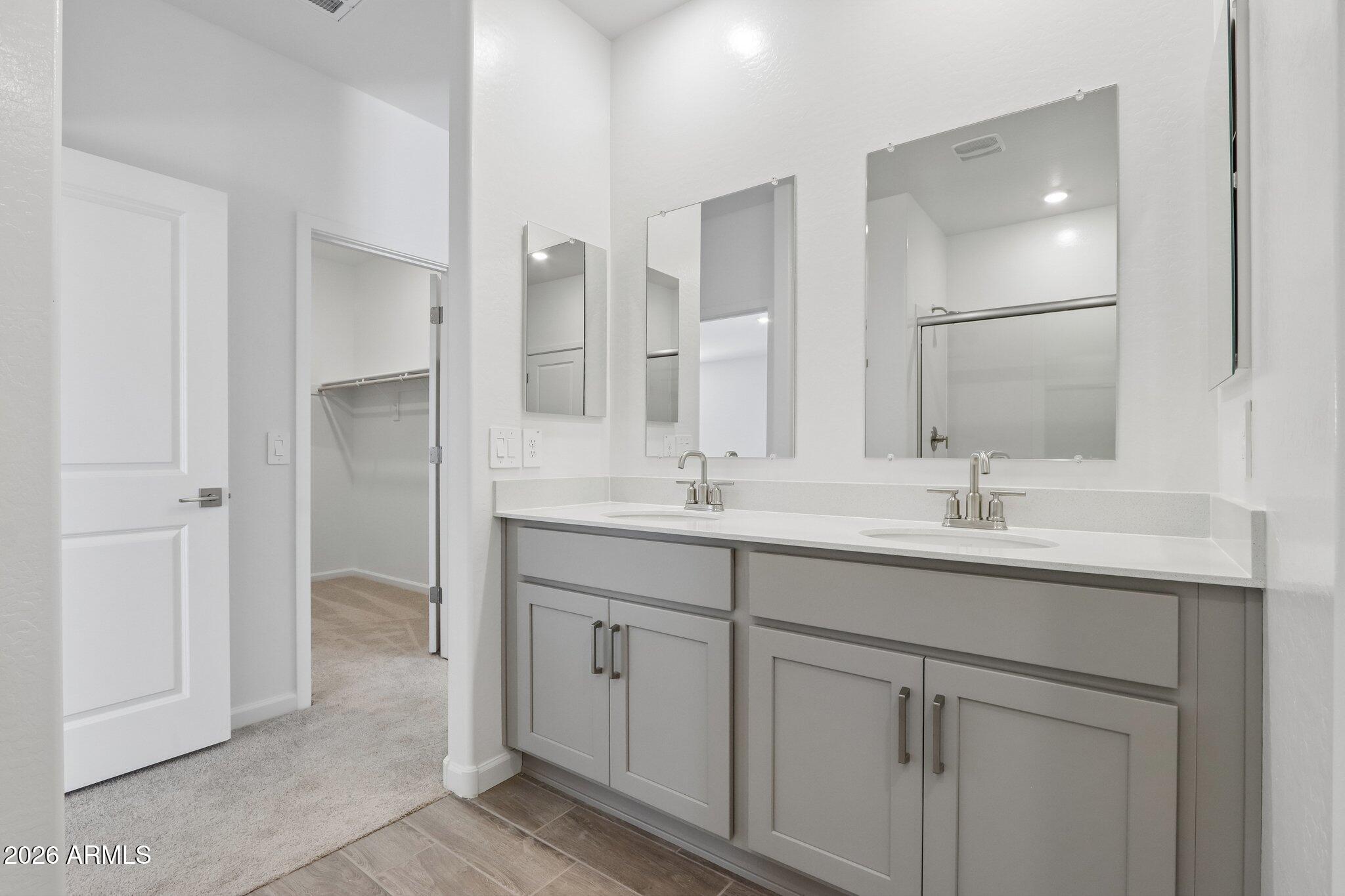 9544 West Gaby Road Tolleson, AZ 85353 - Photo 16 of 43 a bathroom with a double vanity sink and mirror