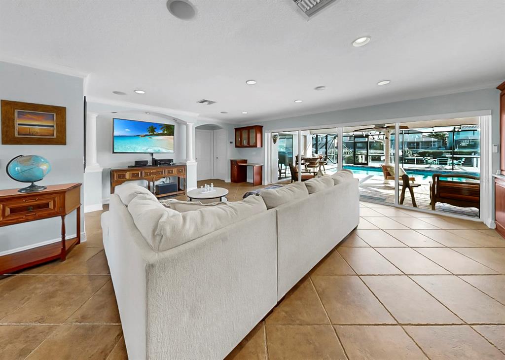 6317 Cocoa Lane Apollo Beach, FL 33572 - Photo 11 of 63 a living room with furniture a flat screen tv and floor to ceiling window
