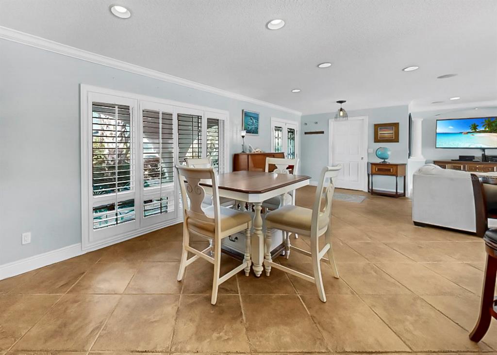 6317 Cocoa Lane Apollo Beach, FL 33572 - Photo 15 of 63 a dining room with furniture and a floor to ceiling window