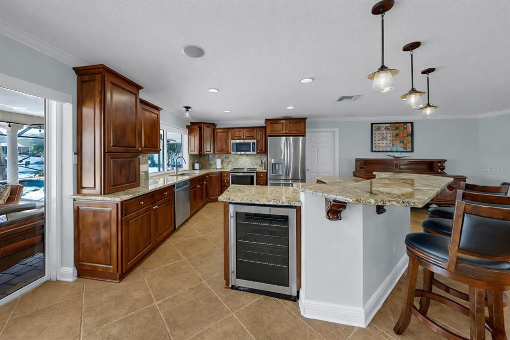6317 Cocoa Lane Apollo Beach, FL 33572 - Photo 20 of 63 a kitchen with kitchen island granite countertop stainless steel appliances lots of counter top space cabinets and a sink