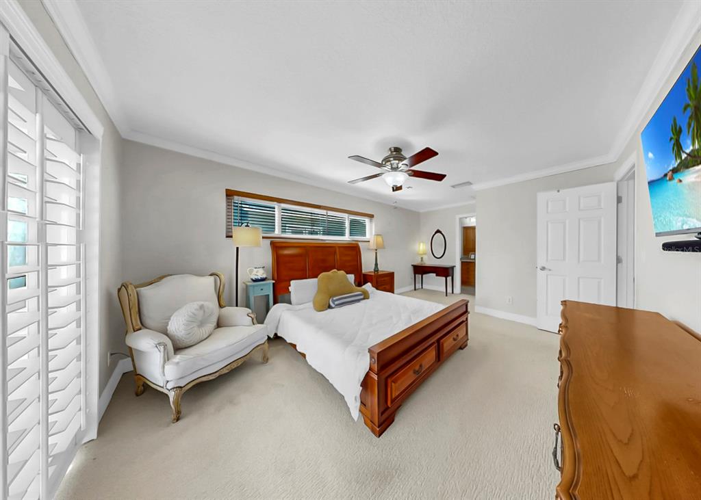 6317 Cocoa Lane Apollo Beach, FL 33572 - Photo 30 of 63 a bedroom with a bed couch and window
