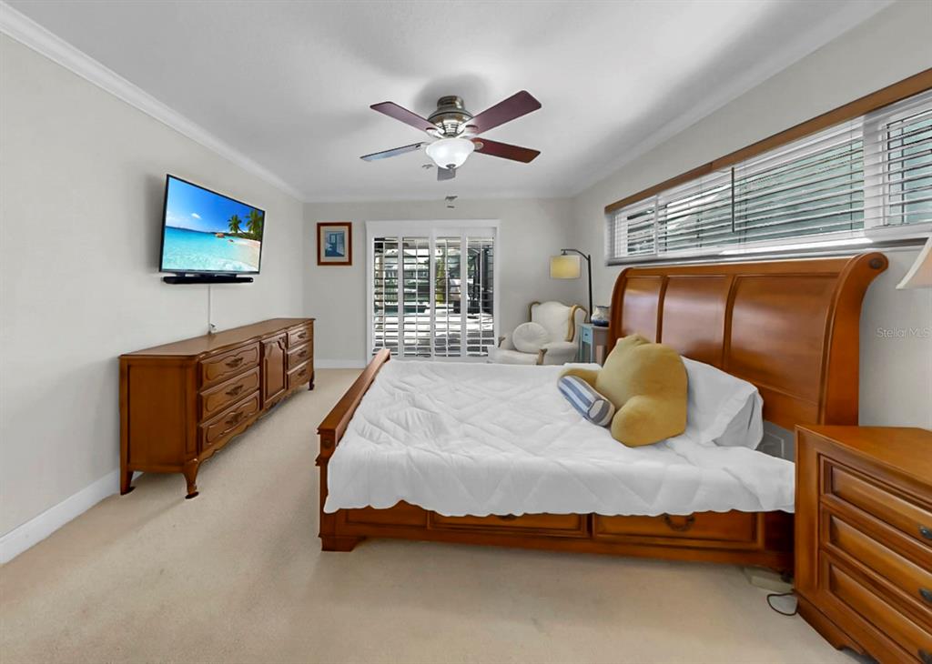 6317 Cocoa Lane Apollo Beach, FL 33572 - Photo 32 of 63 a bedroom with a bed and a chandelier