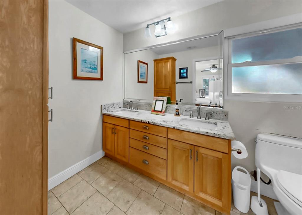 6317 Cocoa Lane Apollo Beach, FL 33572 - Photo 33 of 63 a spacious bathroom with a granite countertop sink mirror and toilet