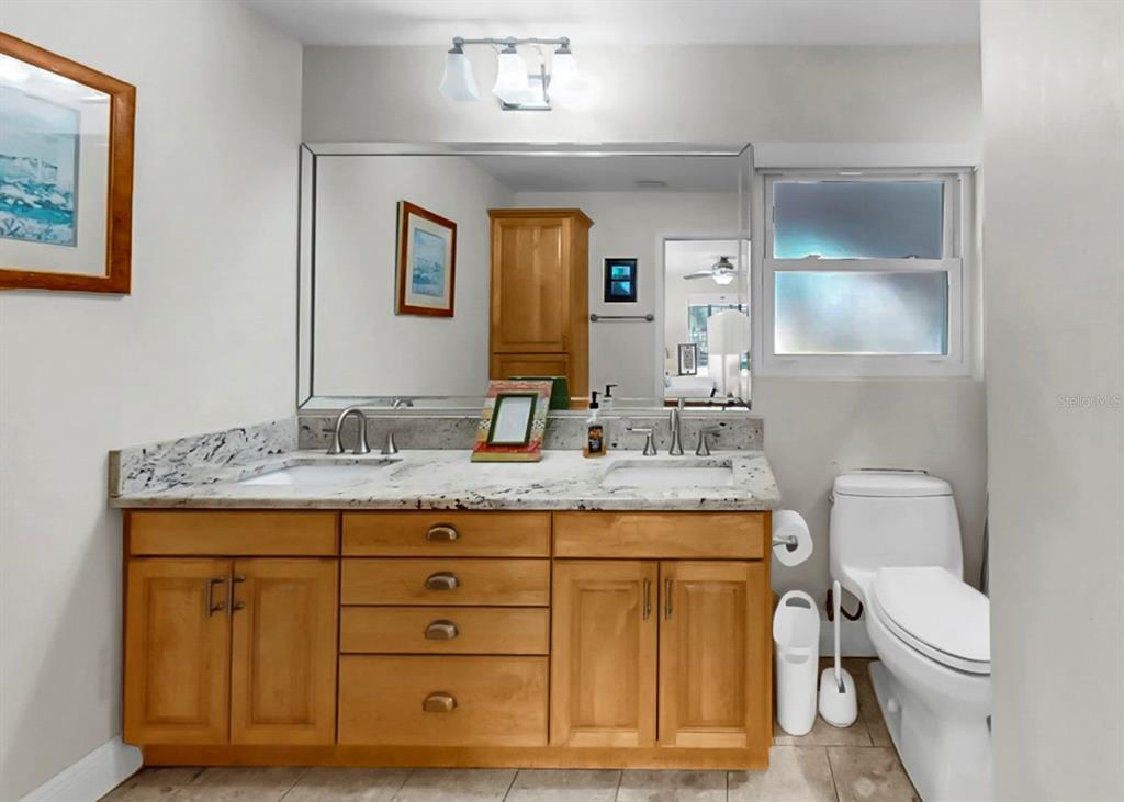 6317 Cocoa Lane Apollo Beach, FL 33572 - Photo 34 of 63 a bathroom with a granite countertop sink and a mirror