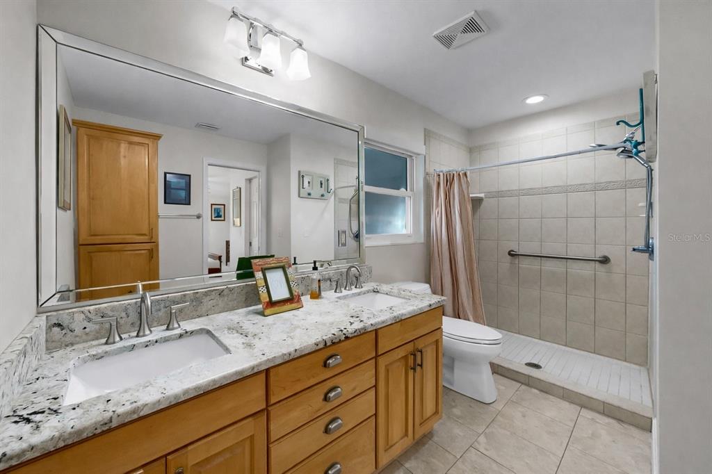 6317 Cocoa Lane Apollo Beach, FL 33572 - Photo 35 of 63 a bathroom with a granite countertop sink toilet and shower
