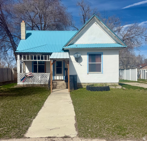 View of front of home featuring a metal roof and a chimney