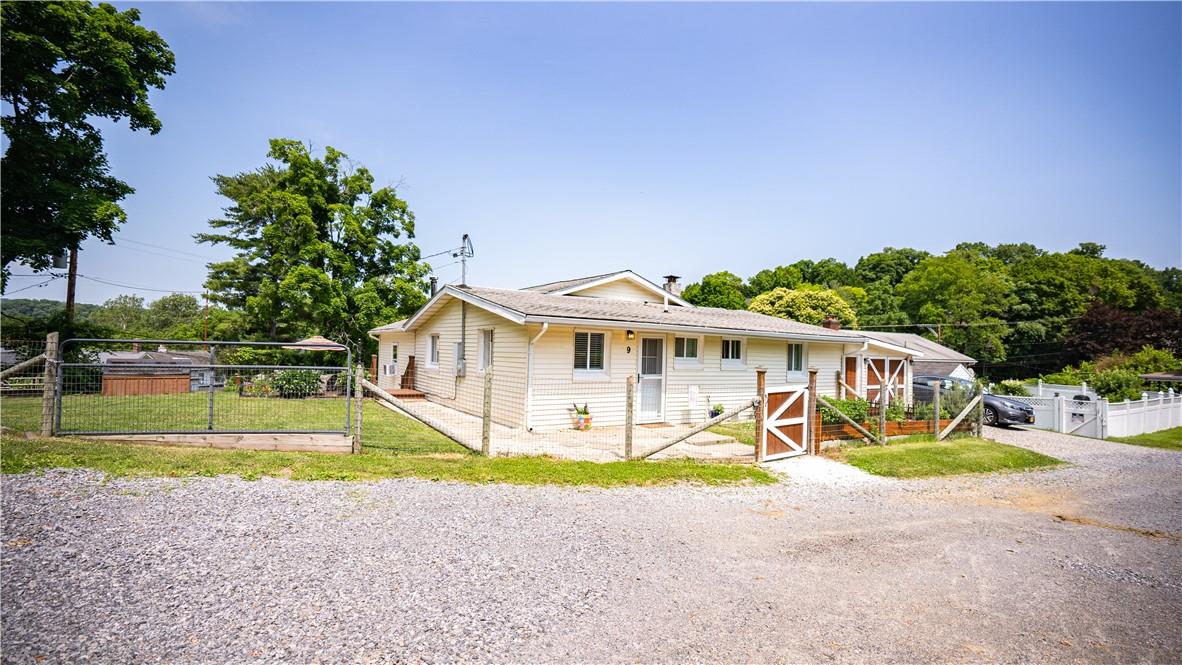 a view of a house with backyard and a small yard