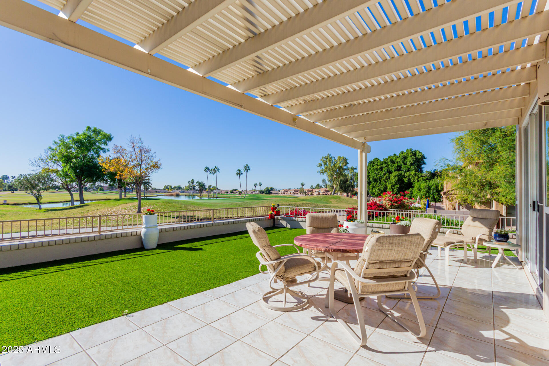 a view of a swimming pool and patio in the backyard