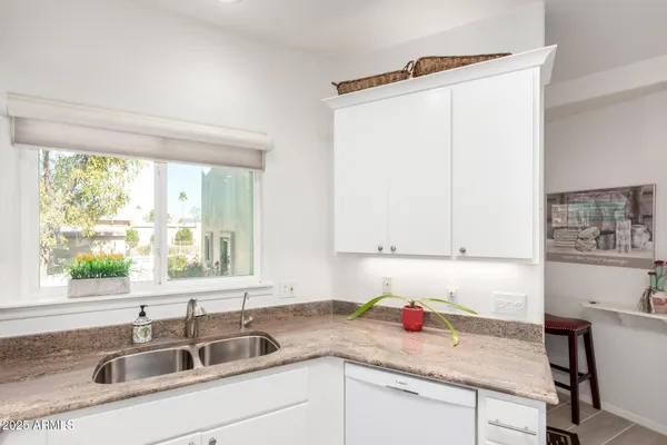 a large kitchen with a table and chairs