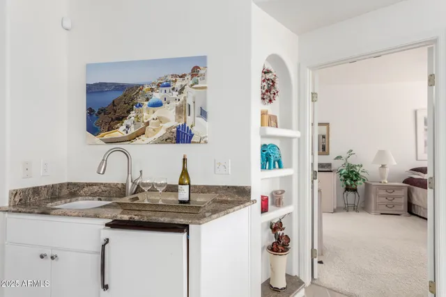 a bedroom with a bed potted plant on table and a window