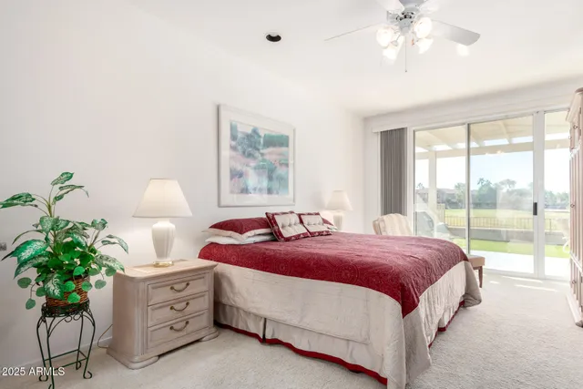 a spacious bedroom with a bed and a chandelier