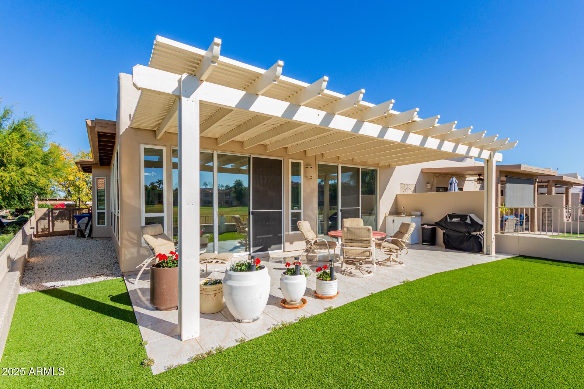 5445 East McKellips Road, Unit 28 Mesa, AZ 85215 - Photo 23 of 39 a front view of a house with garden and porch