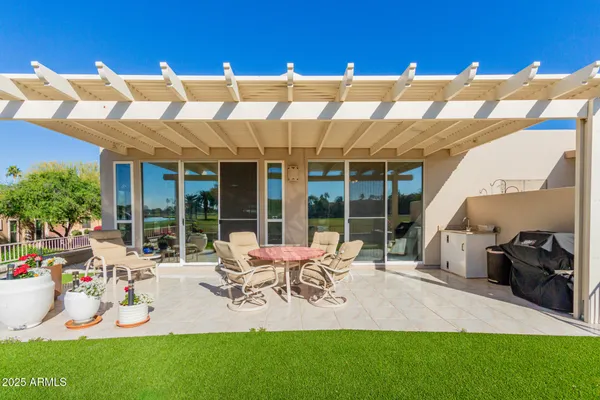 a view of a house with backyard porch and furniture