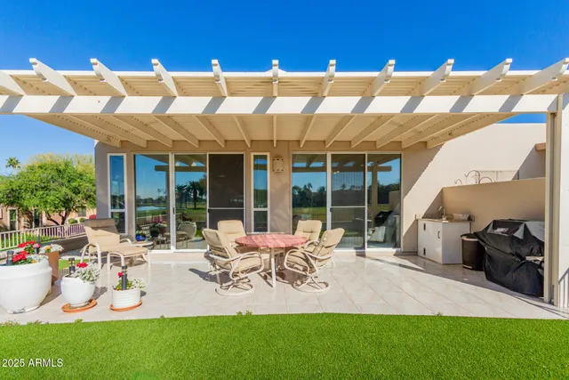a view of a house with backyard porch and furniture