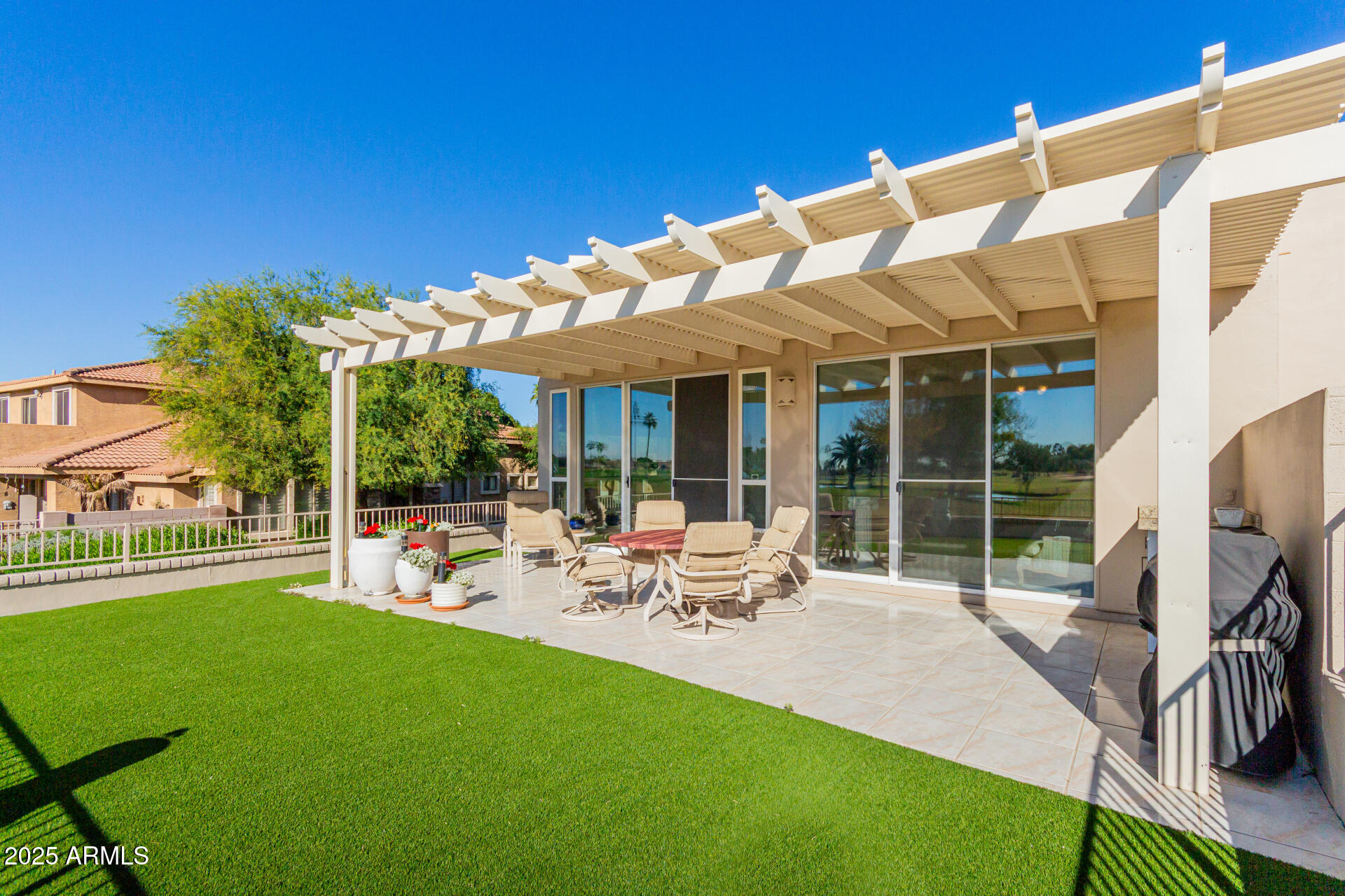 5445 East McKellips Road, Unit 28 Mesa, AZ 85215 - Photo 25 of 39 a view of a house with backyard porch and furniture