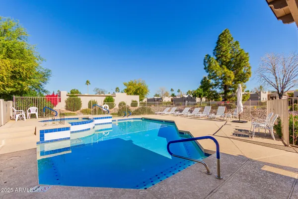 a view of a swimming pool with an outdoor seating