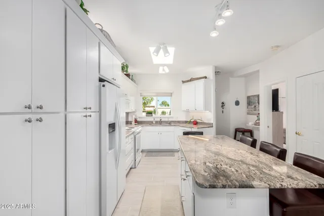 a kitchen with a sink cabinets and window