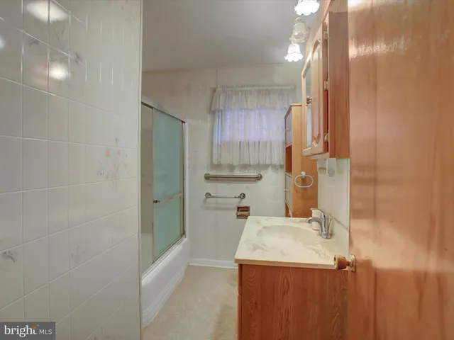 a kitchen with a sink a refrigerator and cabinets