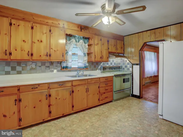 a bathroom with a granite countertop double vanity sink and mirror