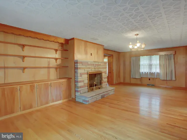 a view of a refrigerator with wooden cabinets