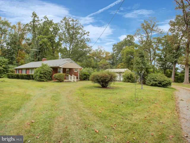 a view of a house with pool and a yard