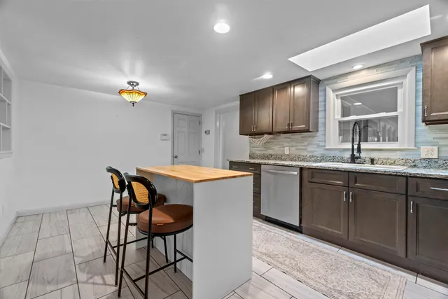 a kitchen with a sink cabinets and window