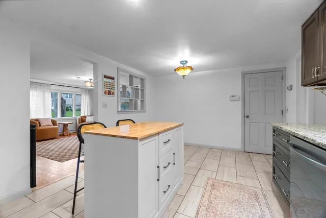 a view of a kitchen with granite countertop a sink and a stove