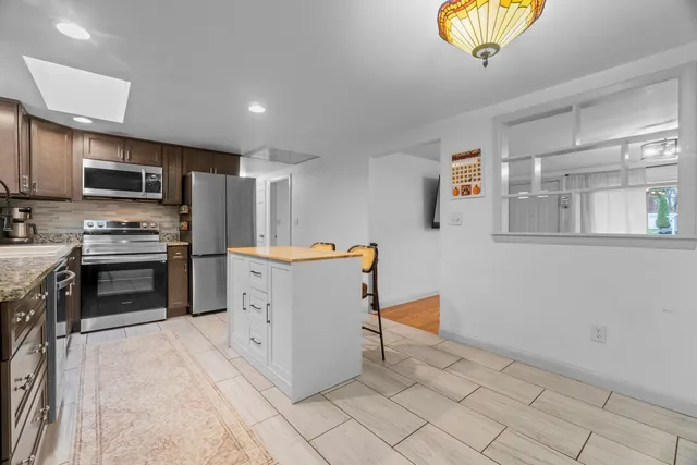 a kitchen with stainless steel appliances a refrigerator and a stove top oven