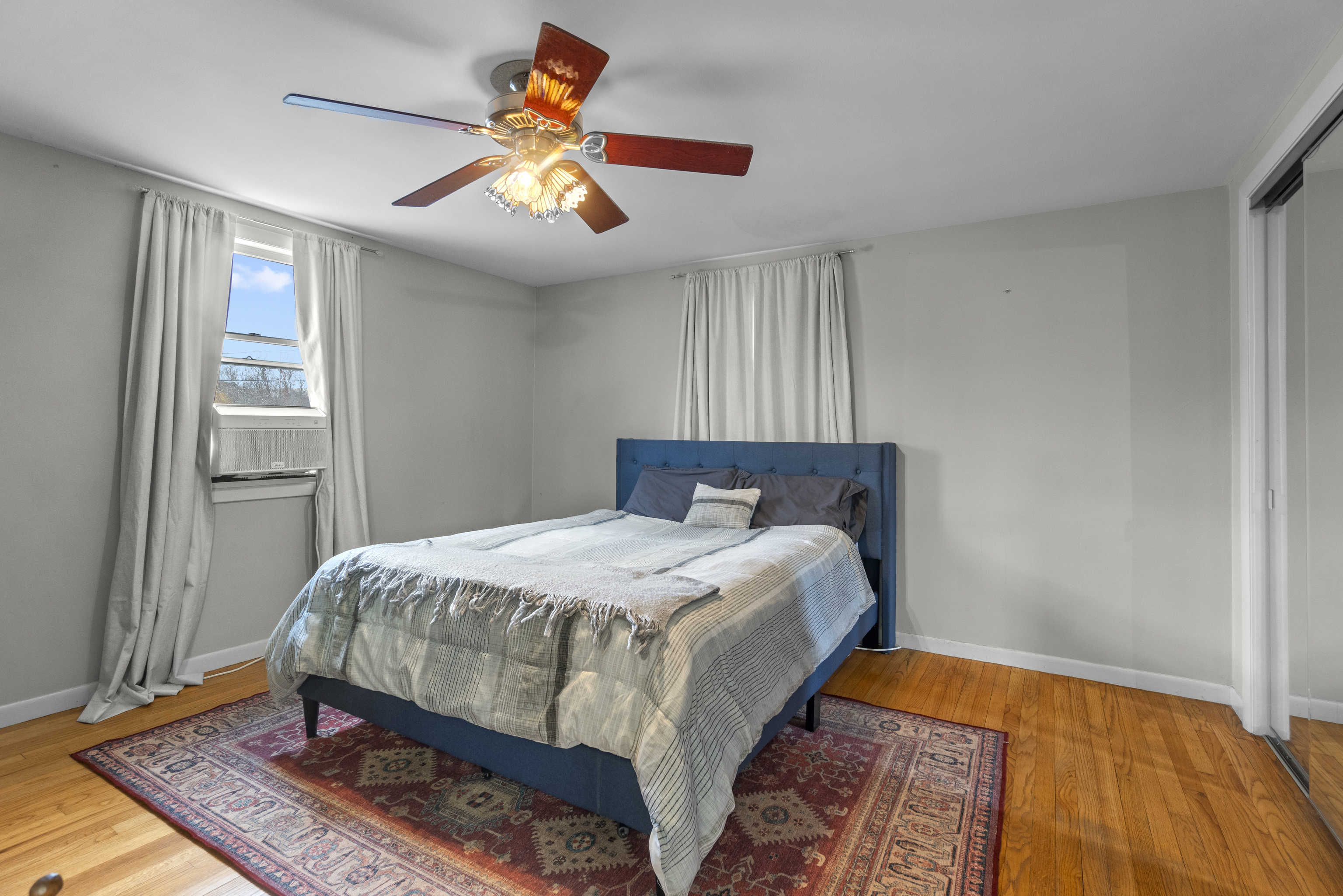 10 Green Acres Lane Thompson, CT 06255 - Photo 17 of 40 a bedroom with a bed and wooden floor