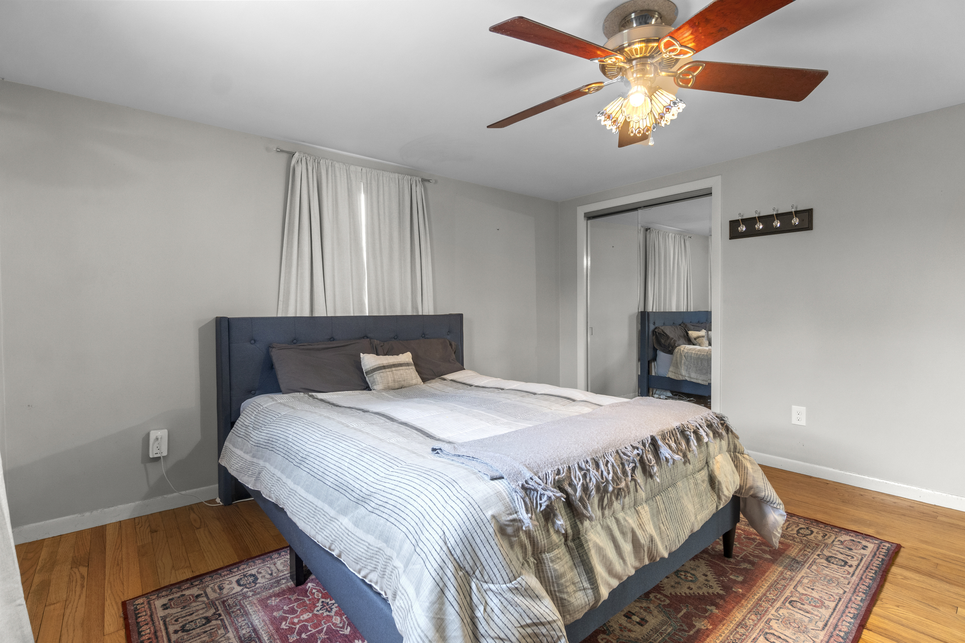 10 Green Acres Lane Thompson, CT 06255 - Photo 19 of 40 a bedroom with a bed and a chandelier