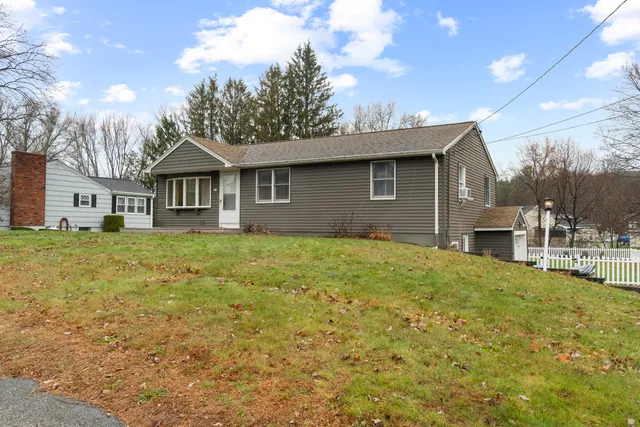 a front view of a house with a garden