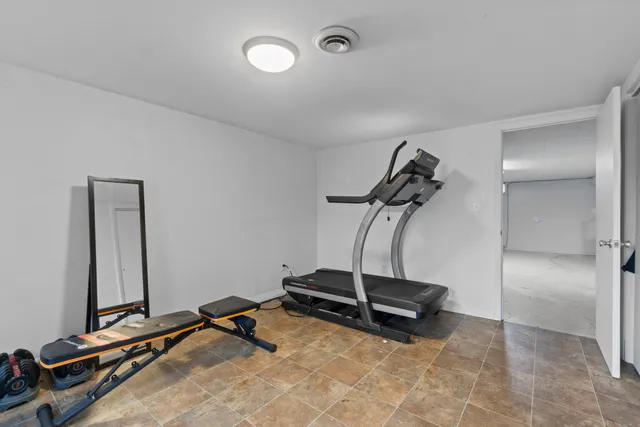 a room with gym equipment and white walls