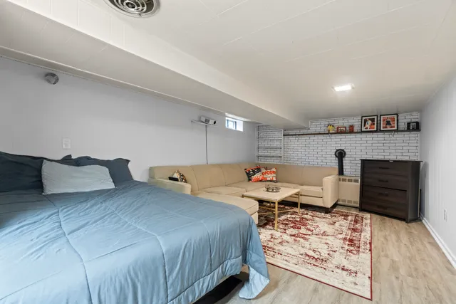 a large bedroom with a bed and furniture