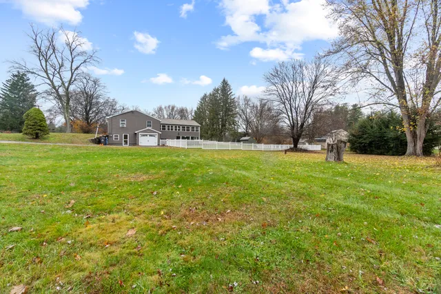 a view of a big yard with a house in the background