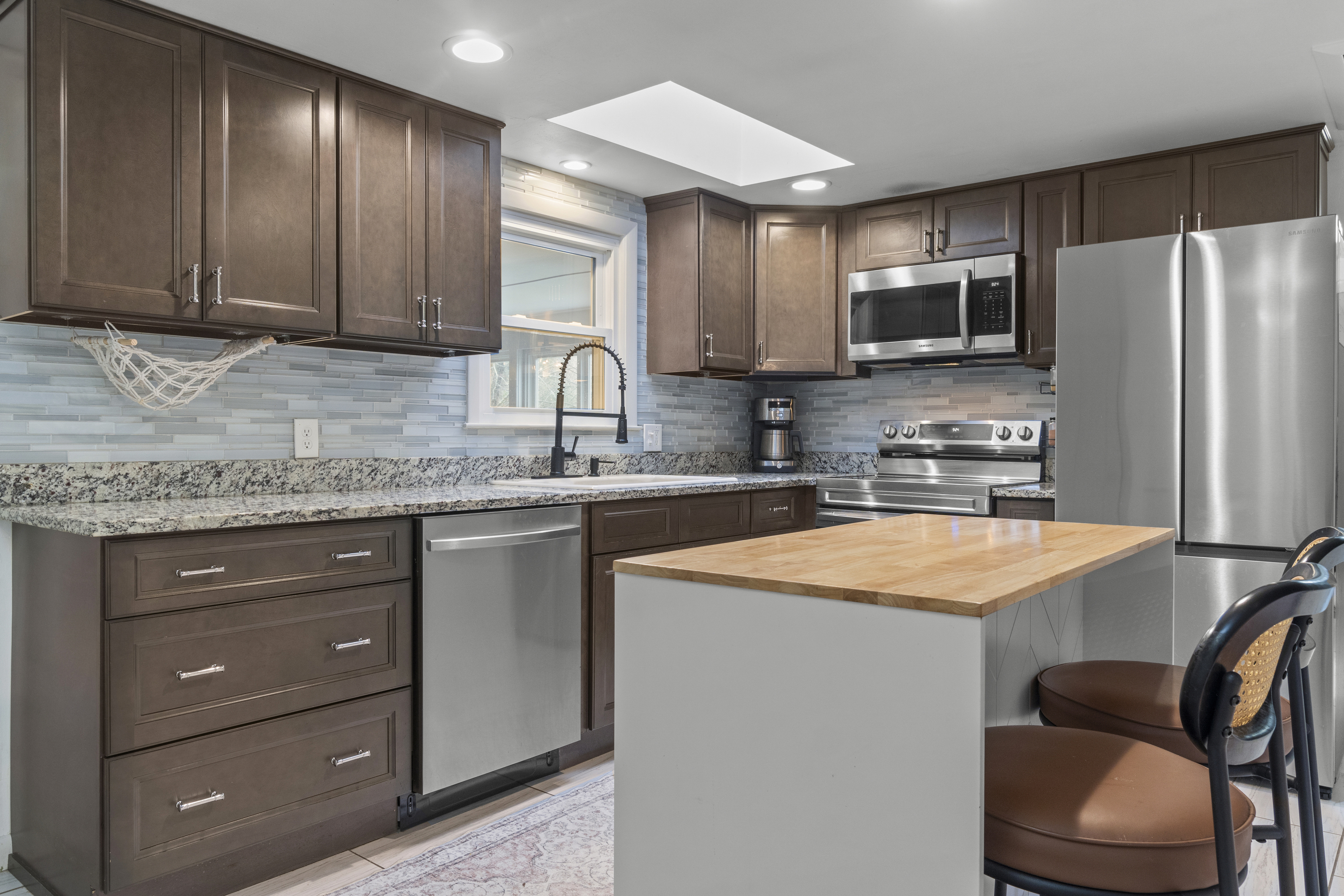 10 Green Acres Lane Thompson, CT 06255 - Photo 10 of 40 a kitchen with stainless steel appliances granite countertop a sink stove refrigerator and cabinets