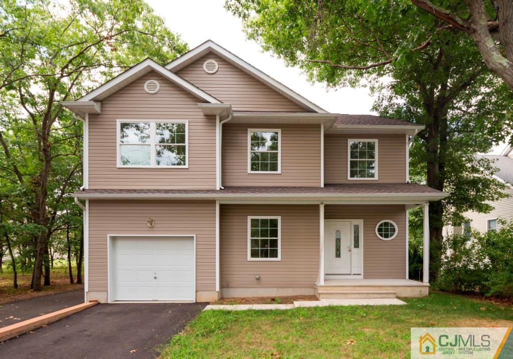 388 Aldrich Road Howell, NJ 07731 - Photo 1 of 24 a front view of a house with garden