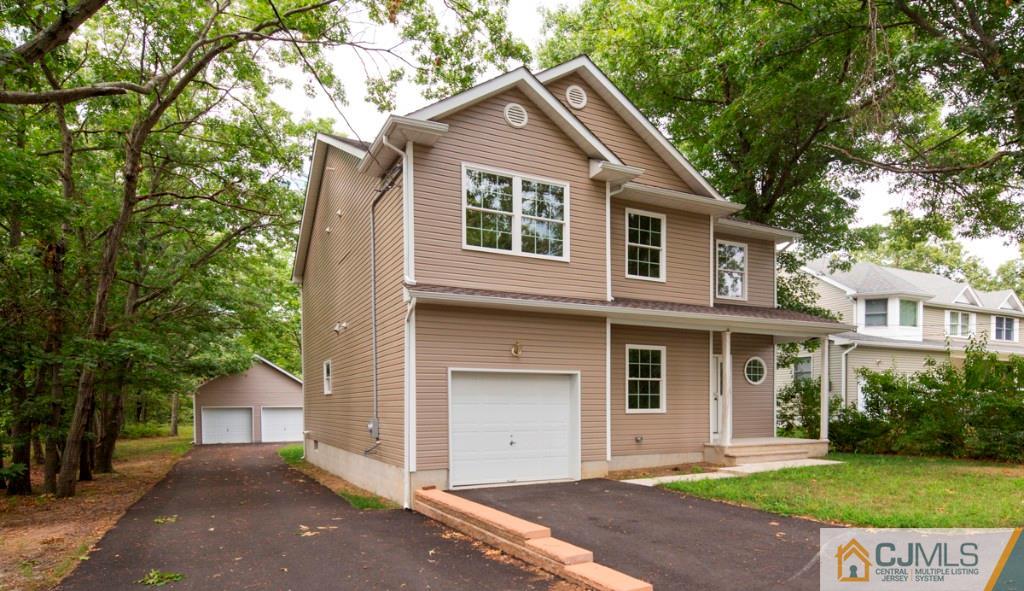 388 Aldrich Road Howell, NJ 07731 - Photo 2 of 24 a front view of a house with a yard and garage