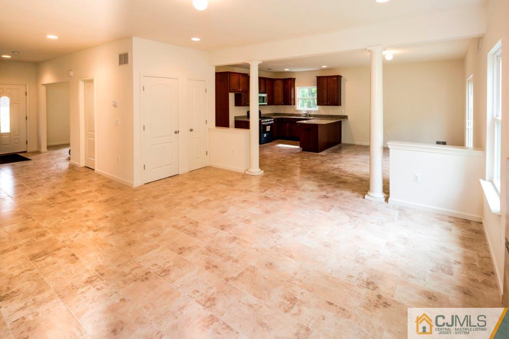 388 Aldrich Road Howell, NJ 07731 - Photo 12 of 24 a view of a living room with kitchen furniture and windows