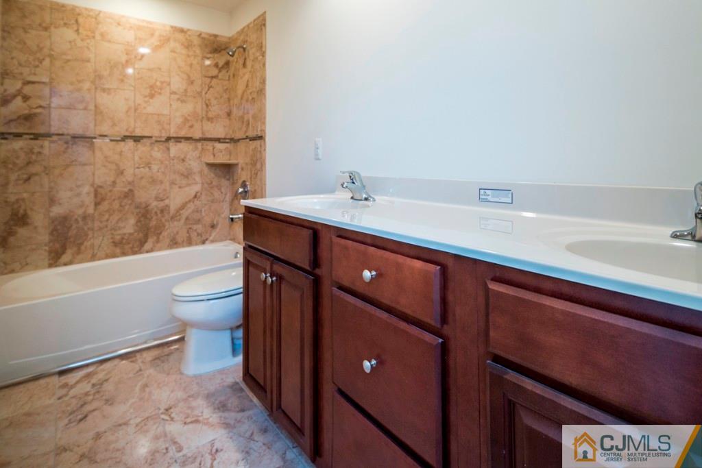 388 Aldrich Road Howell, NJ 07731 - Photo 18 of 24 a bathroom with a sink a toilet and shower