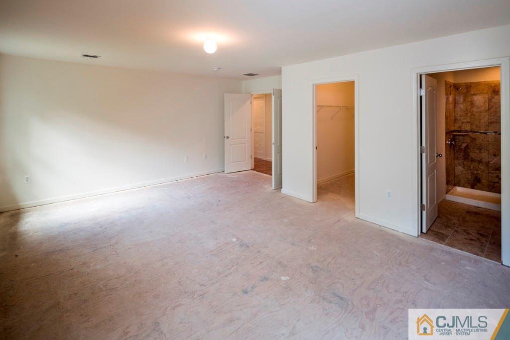 388 Aldrich Road Howell, NJ 07731 - Photo 20 of 24 an empty room with closet and mirrors