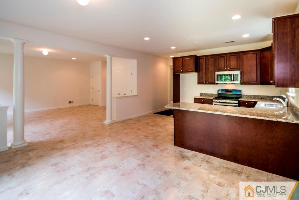 388 Aldrich Road Howell, NJ 07731 - Photo 8 of 24 a kitchen with stainless steel appliances granite countertop a refrigerator and a stove