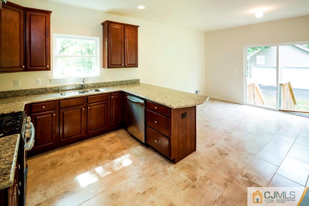 388 Aldrich Road Howell, NJ 07731 - Photo 9 of 24 a kitchen with stainless steel appliances granite countertop a stove a sink and a microwave