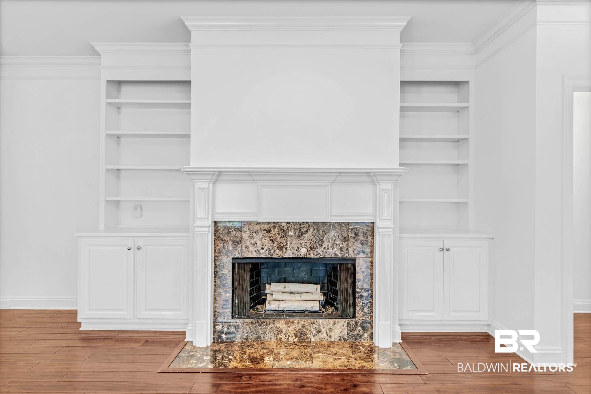 105 Cedar Pointe Fairhope, AL 36532 - Photo 10 of 38 Detailed view of built in features, ornamental molding, wood finished floors, and a fireplace