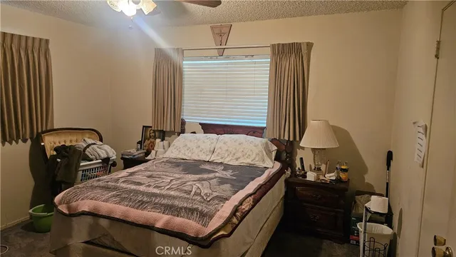 a bed sitting in a bedroom next to a window