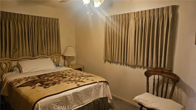 a bedroom with a bed and a chair