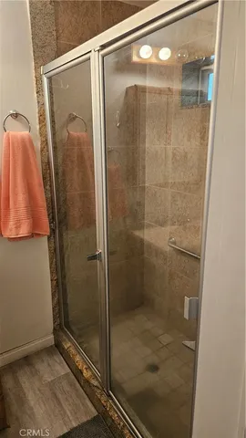 a bathroom with a glass shower door